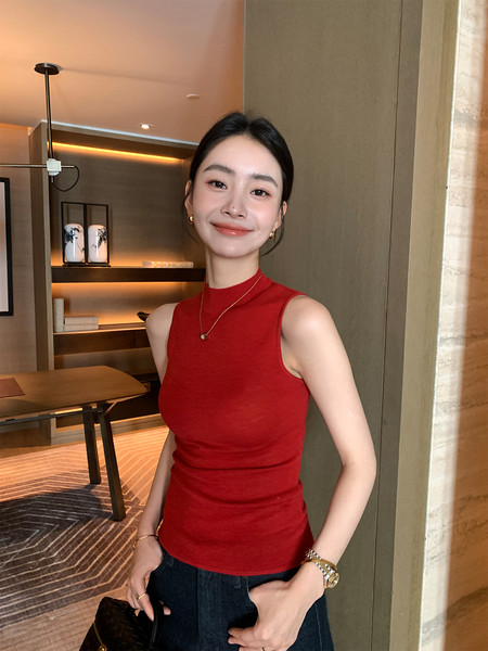 Red sleeveless high-neck top worn by a model