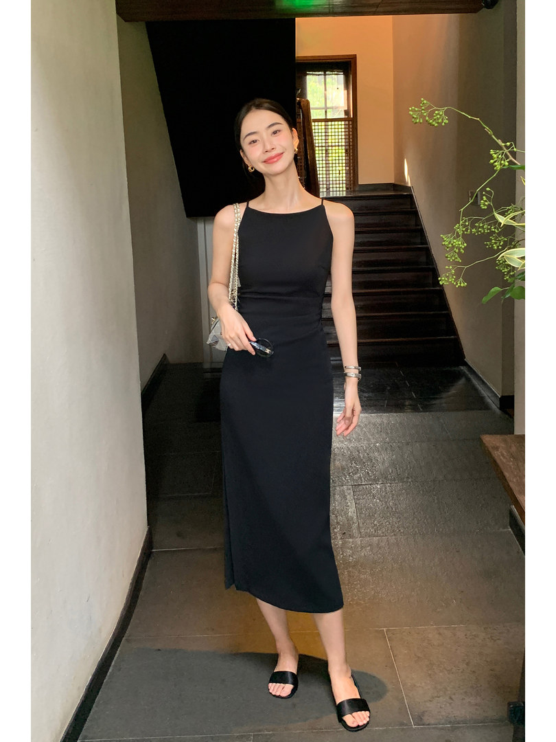Black sleeveless midi dress worn by a model