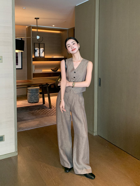 Woman wearing a beige sleeveless vest and wide-leg pants set