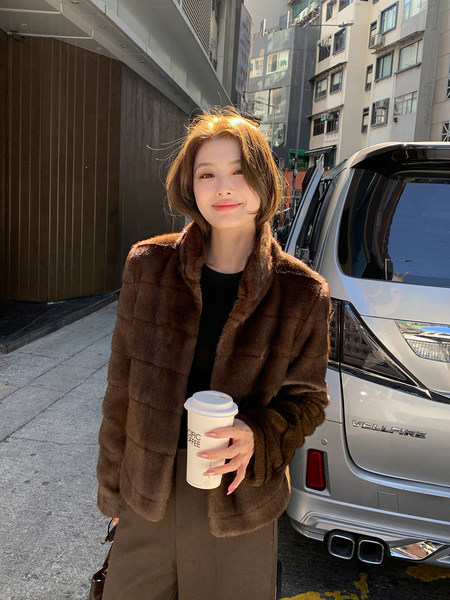 Woman wearing a brown fur coat outdoors