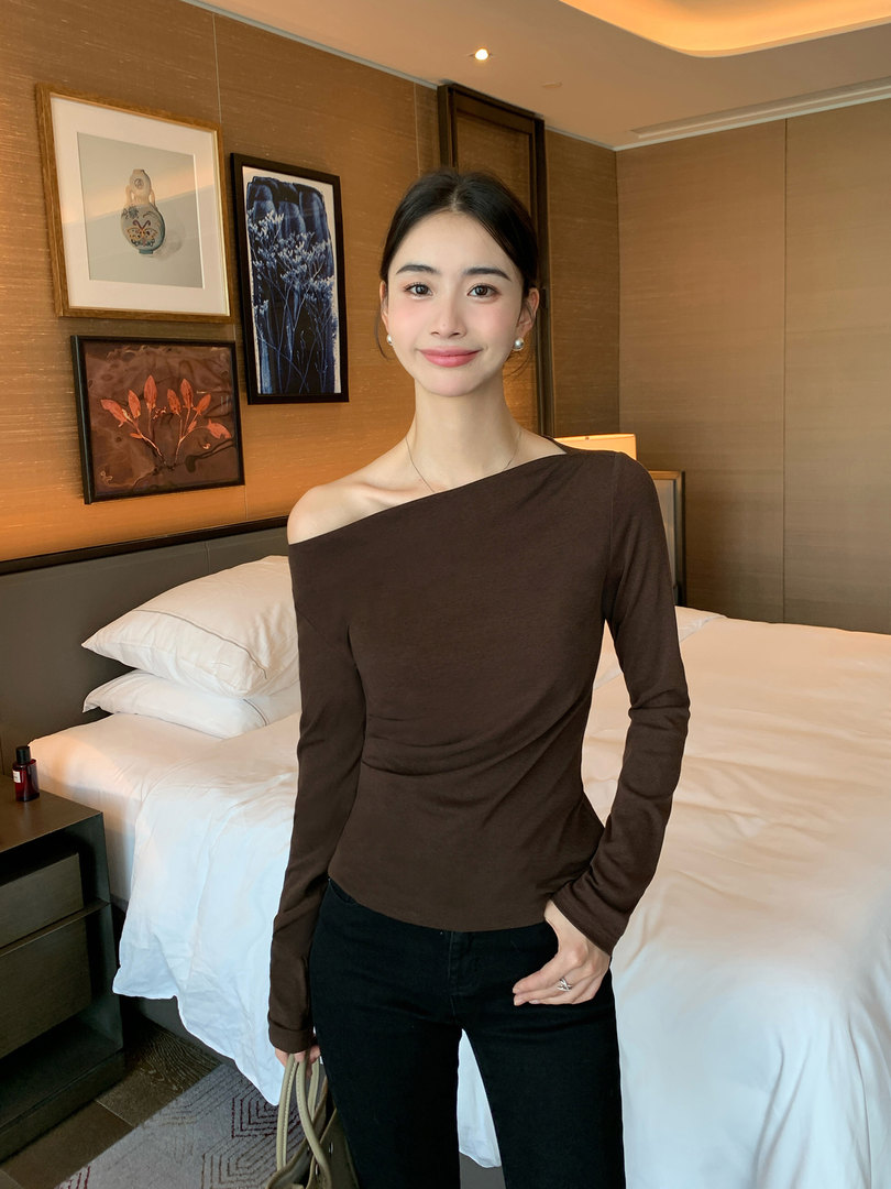 Brown off-shoulder long-sleeve fitted top worn by a woman