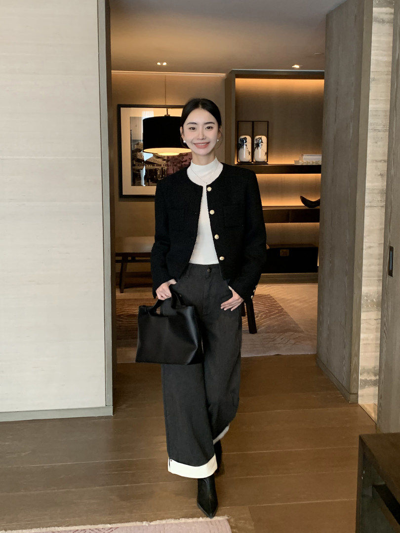 Woman wearing a black tailored jacket with wide-leg trousers and a white top