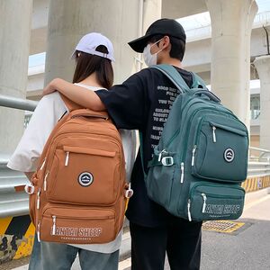 新款初中生书包帅气高中生大容量耐脏减负护脊大学生旅行双肩包
