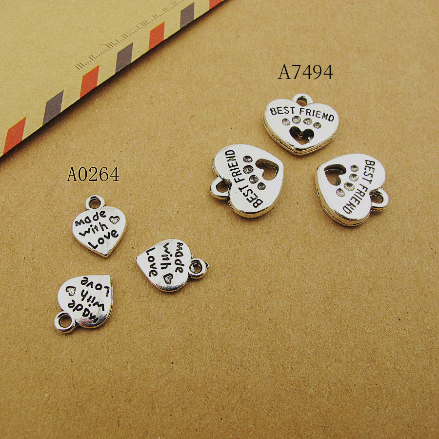 A0264桃心1000克/1666个包0.6克12x10mm古银字母镂空猫爪合金配件