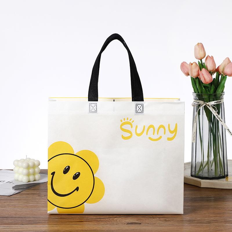 新款直销新款加厚覆膜无纺布可爱太阳花笑脸女装童装手提购物服装