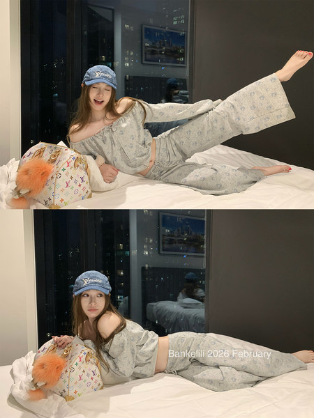Gray off-shoulder loungewear set worn by a model on a bed