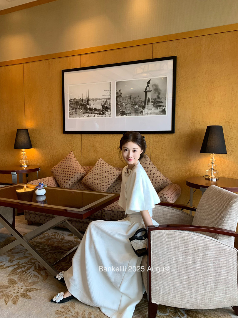 Woman wearing a white elegant dress in a lounge setting