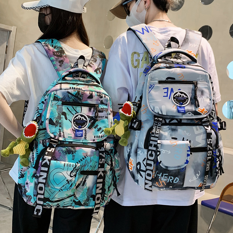 双肩包男潮酷涂鸦新款大学生休闲旅行电脑背包初中高中学生书包女
