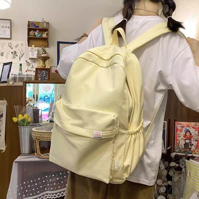 新品奶黄色书包女生初中生大容量双肩包日系简约纯色大学生学院风
