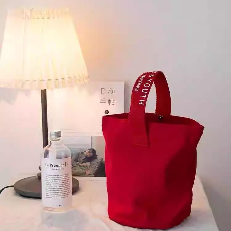 新款chic简约帆布水桶手提休闲拎包百搭小拎包可携式饭盒手机包