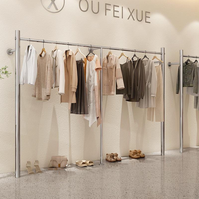 高端服装店网红货架展示架陈列架上墙不锈钢女装店挂衣架上墙架图片