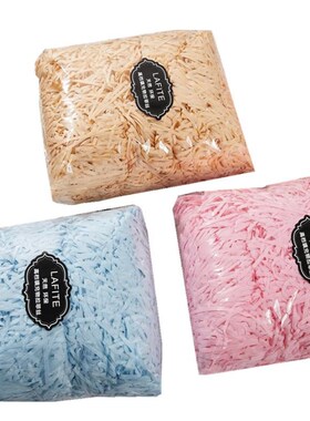 gift lined with shredded paper filling, colored packing box