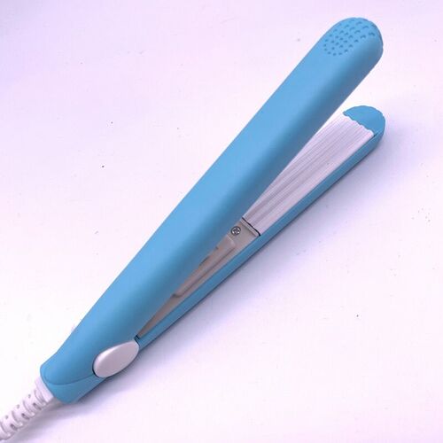 A mini hair iron pink corrugated plate electric curling iron