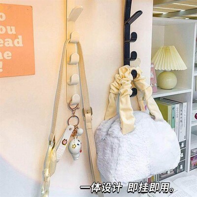 Behind the door, a long row of hooks serves as a bag hanger
