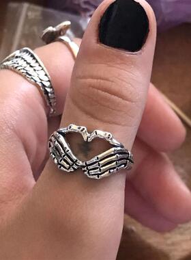 Retro skull hand with heart-shaped ring creative couple stai