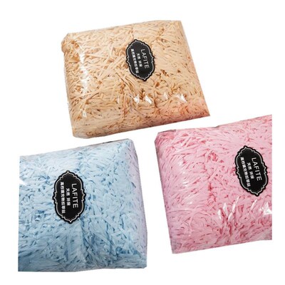 gift lined with shredded paper filling, colored packing box