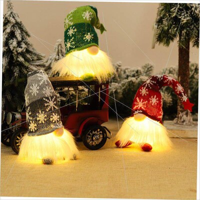 Woven woodman ornaments sit under Christmas lights灯