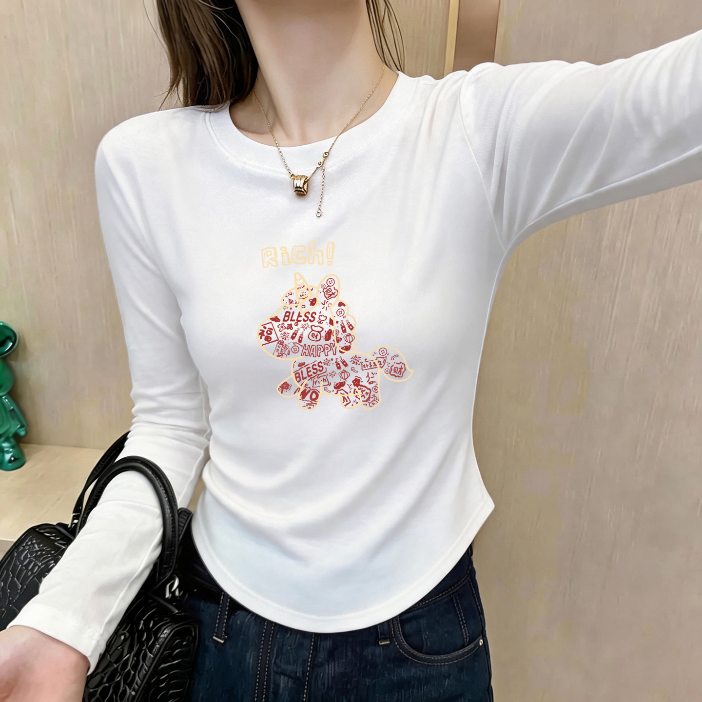 2026春装辣妹风弧形下摆长袖T恤女圆领卡通印花修身内搭短款上衣图片