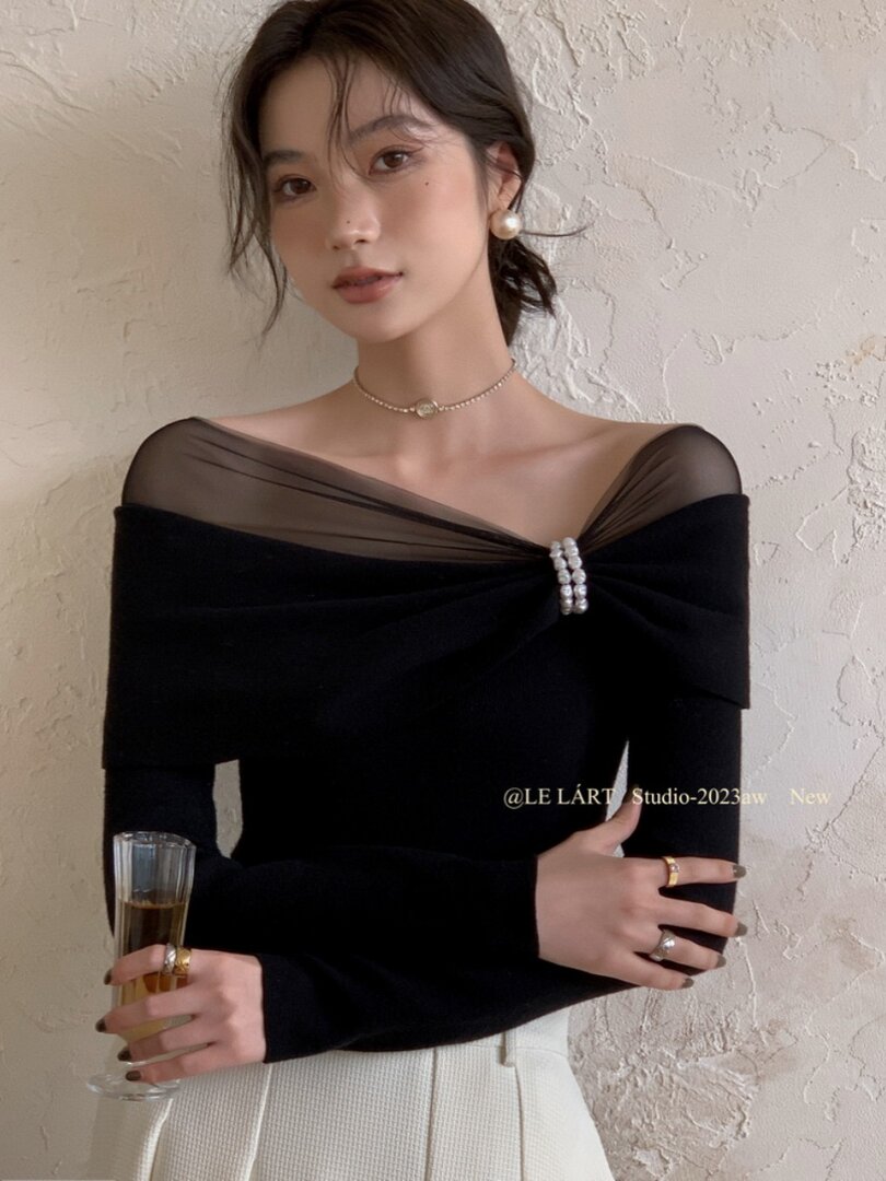 Black off-shoulder fitted top worn by a model