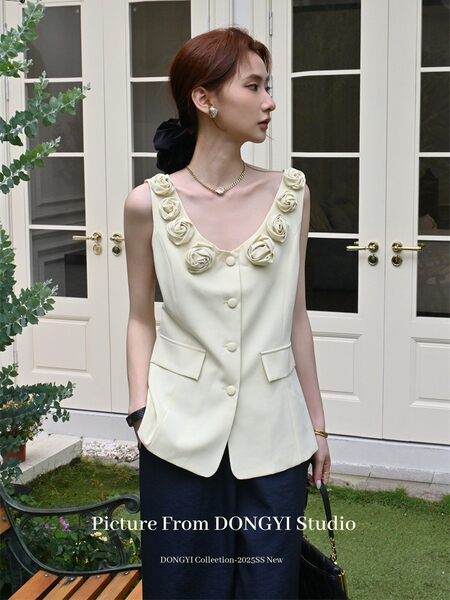 Cream sleeveless embellished vest top worn by a model