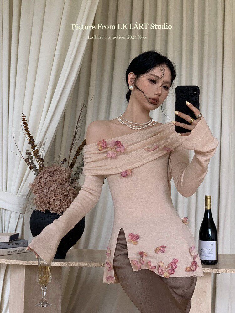 Woman wearing a pale pink off-shoulder floral embellished dress