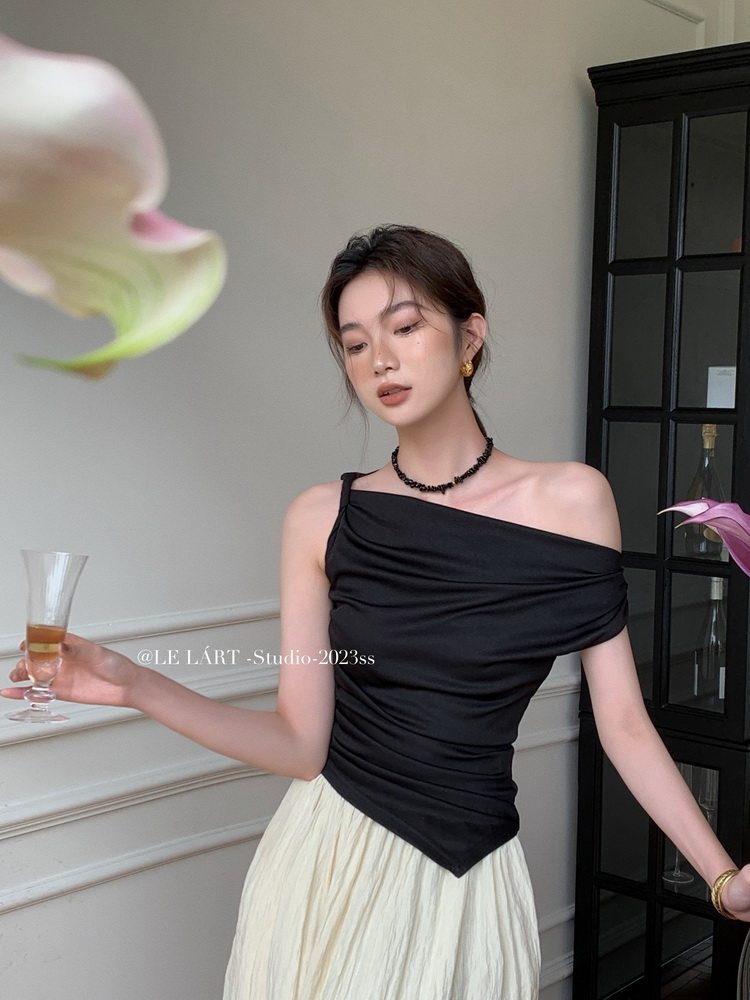 Woman wearing a black off-shoulder top with a light flowing skirt