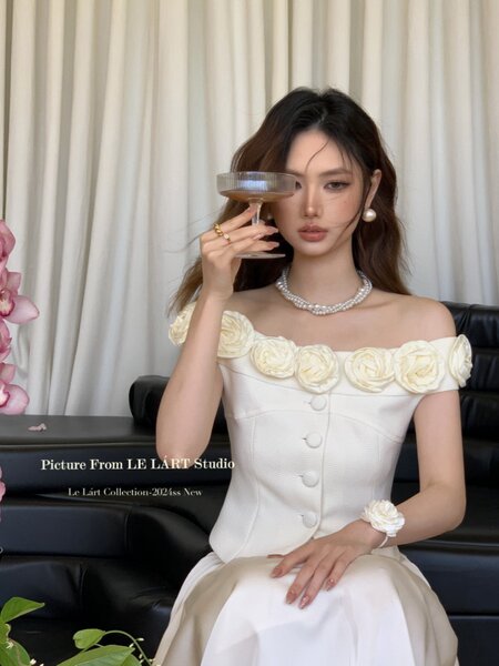 White off-shoulder floral dress worn by a model