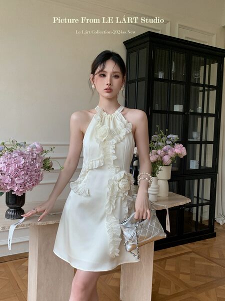 White halter ruffled dress worn by a model