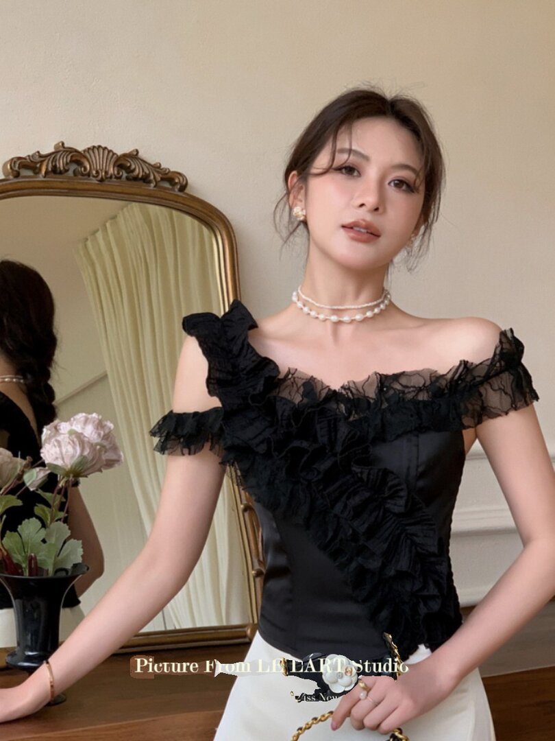 Black off-shoulder ruffled top worn by a model