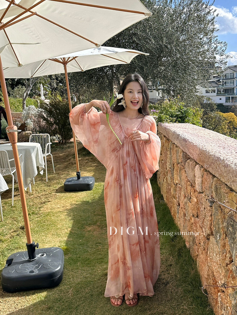 Woman wearing a flowing peach maxi dress outdoors