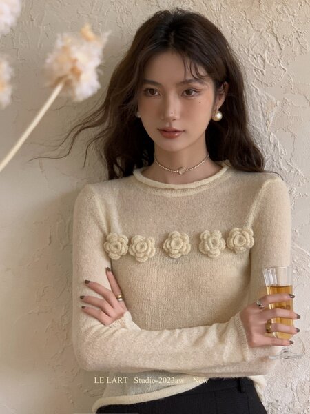 Cream long-sleeve knit sweater with floral applique worn by a model