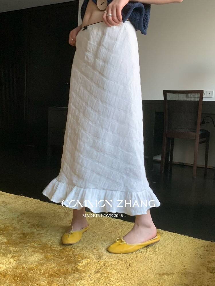 White ruffled maxi skirt worn with yellow flats
