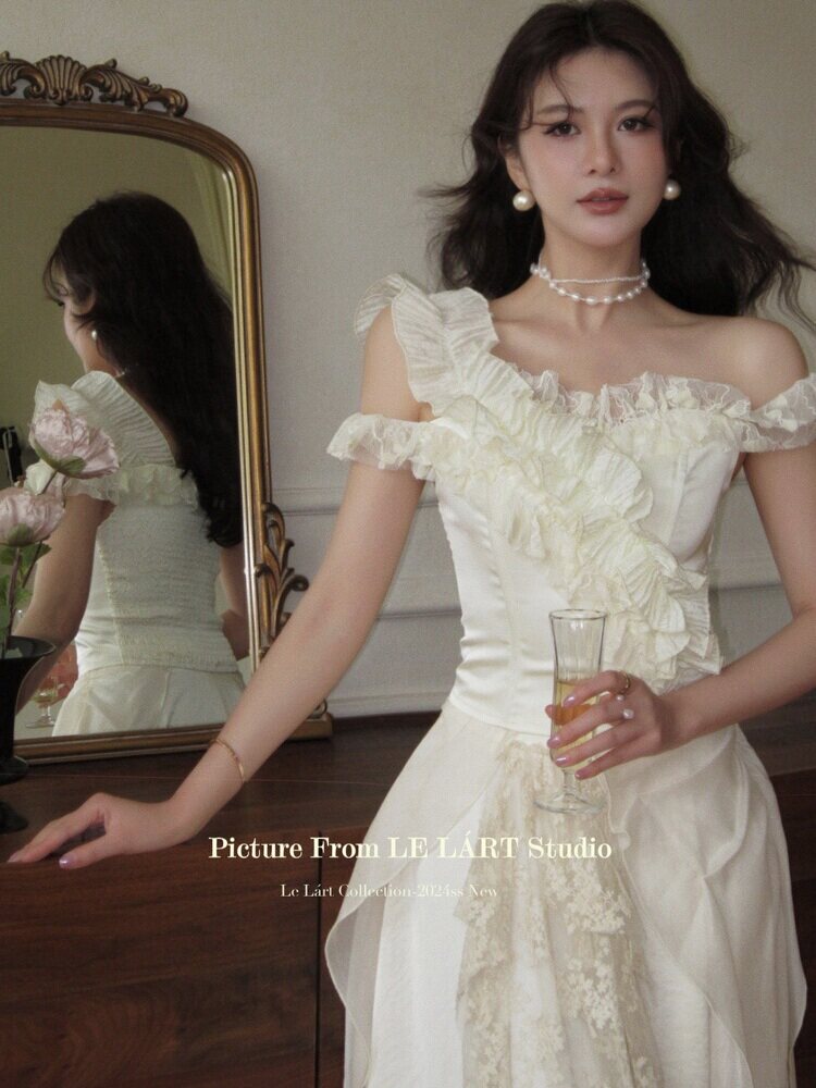 White off-shoulder ruffled dress worn by a model