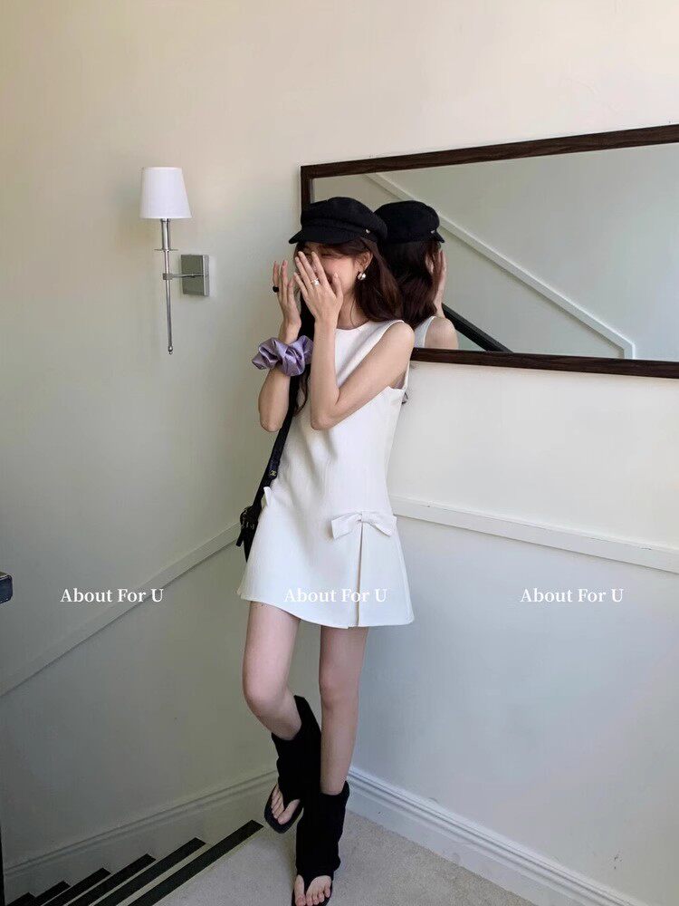 White sleeveless mini dress worn by a model