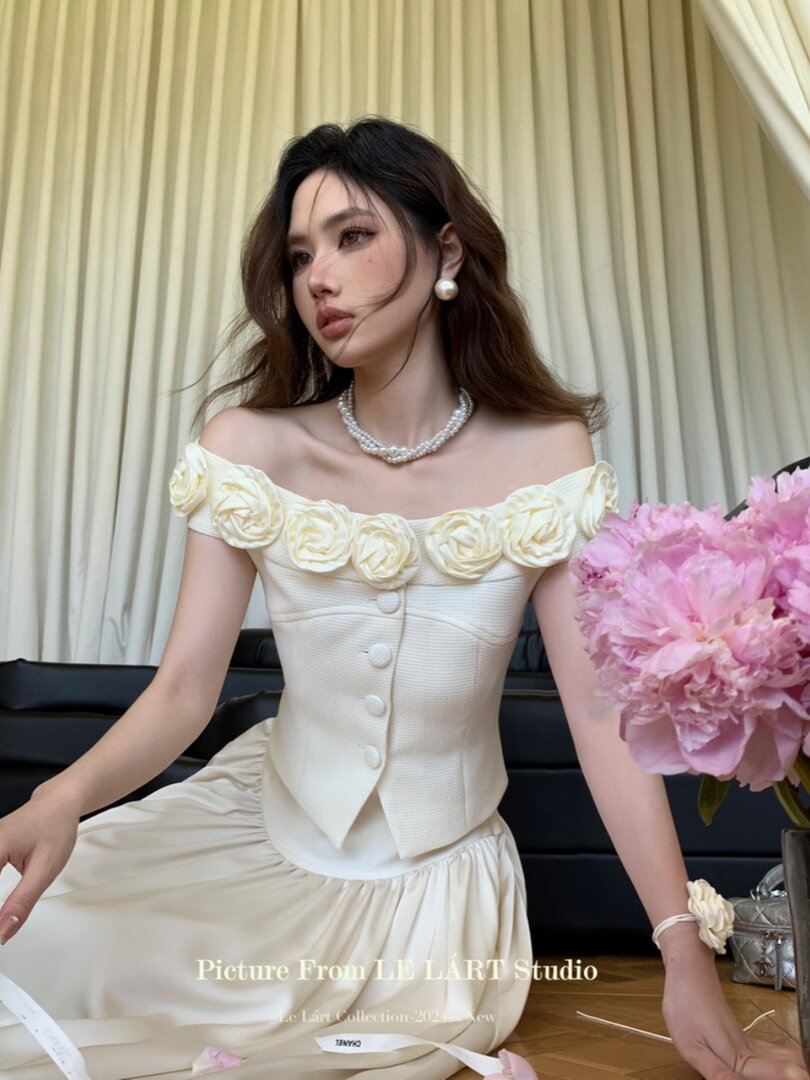 Cream off-shoulder floral dress worn by a model