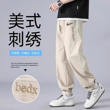 耐克顿休闲裤子男款秋冬季潮牌加肥宽松青少年刺绣工装束脚长裤子