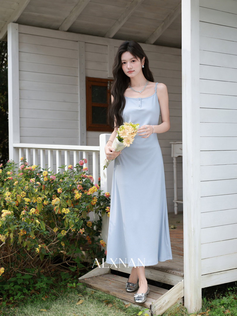 Light blue sleeveless midi dress worn by a model outdoors