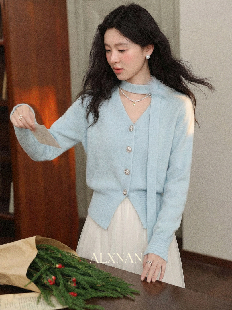 Light blue cardigan sweater worn over a white skirt