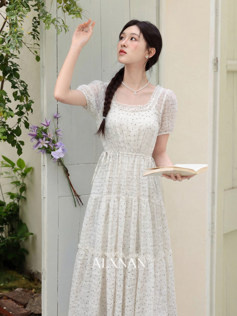 White short-sleeve ruffled dress worn by a model