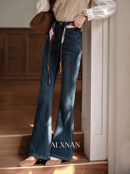 Blue flared jeans worn by a model with a blouse and flats