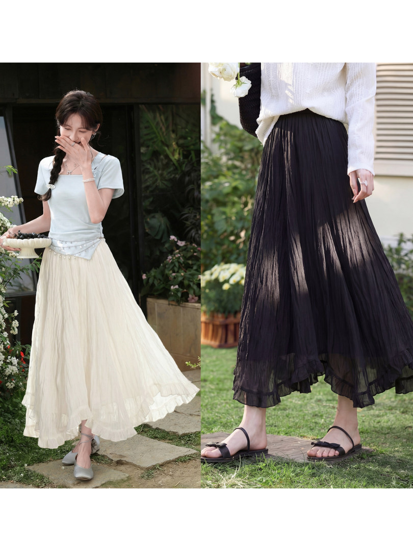 Women modeling a flowing pleated midi skirt in white and black