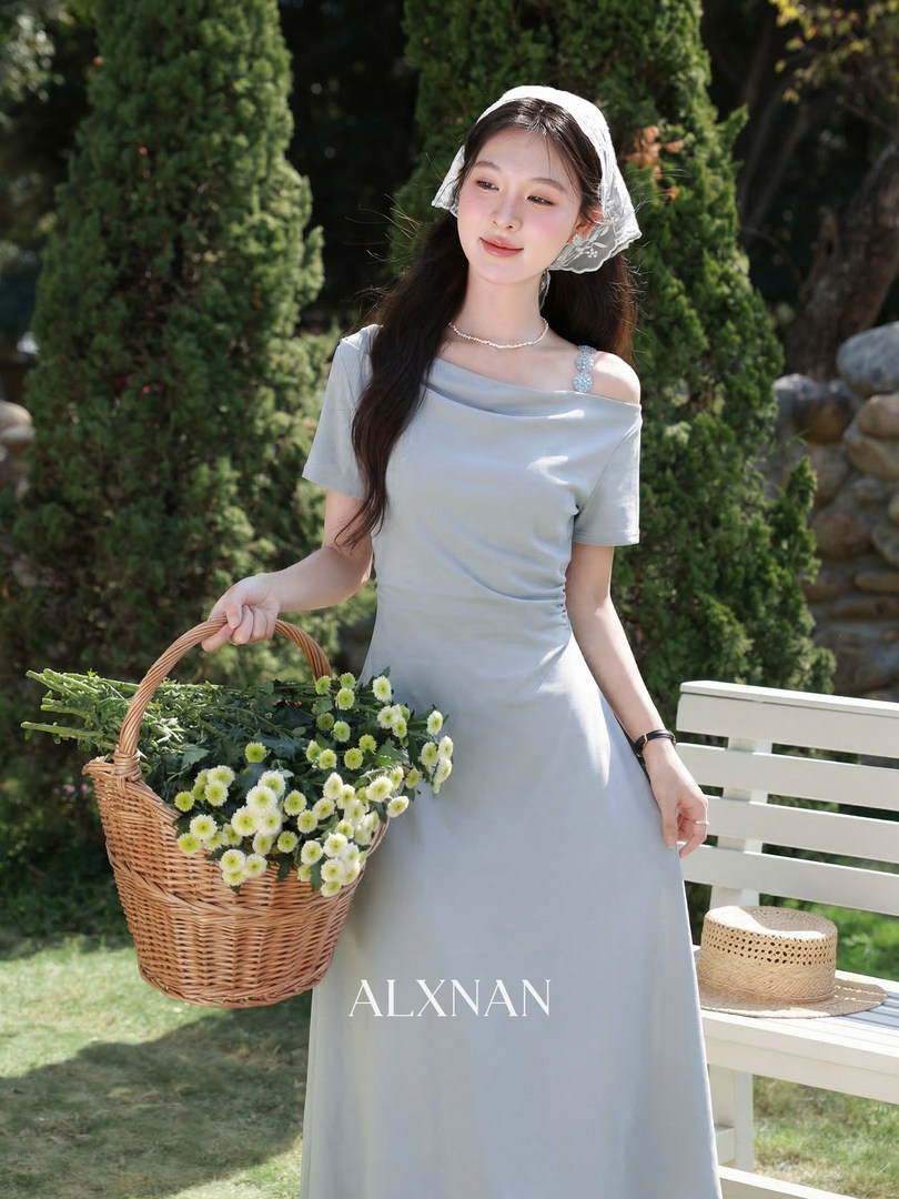 Light gray off-shoulder dress worn by a model outdoors