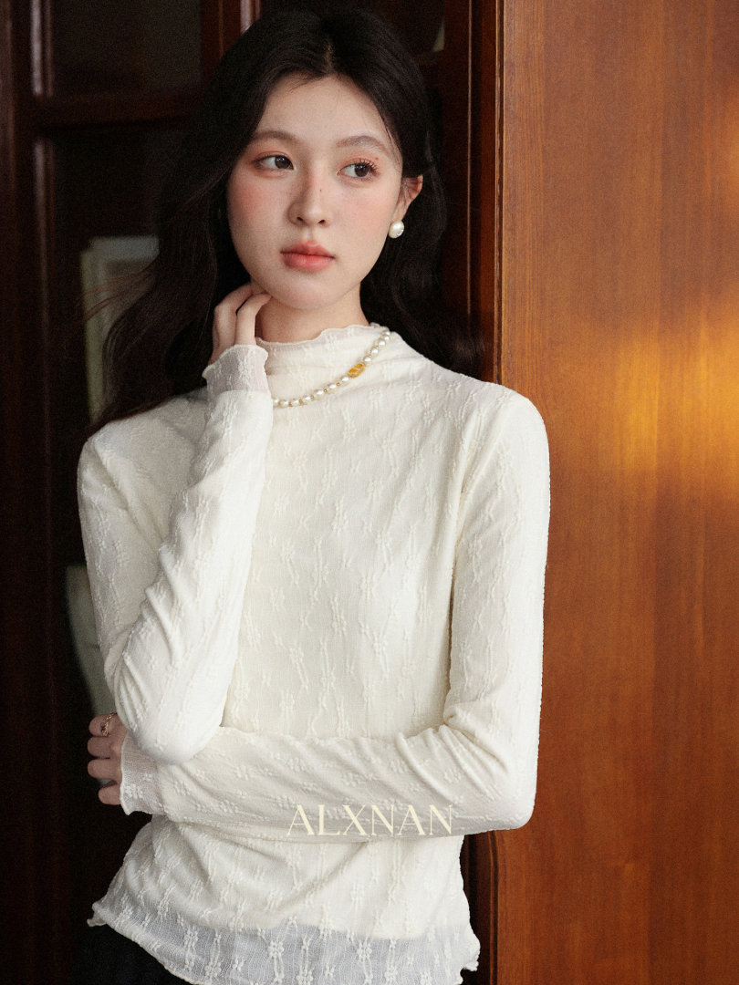 White long-sleeve textured lace top worn by a model