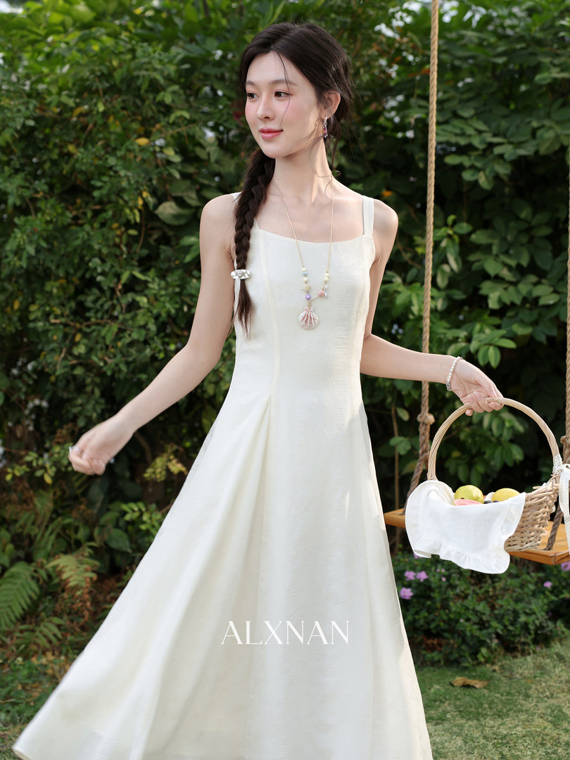 Woman wearing a white sleeveless maxi dress outdoors