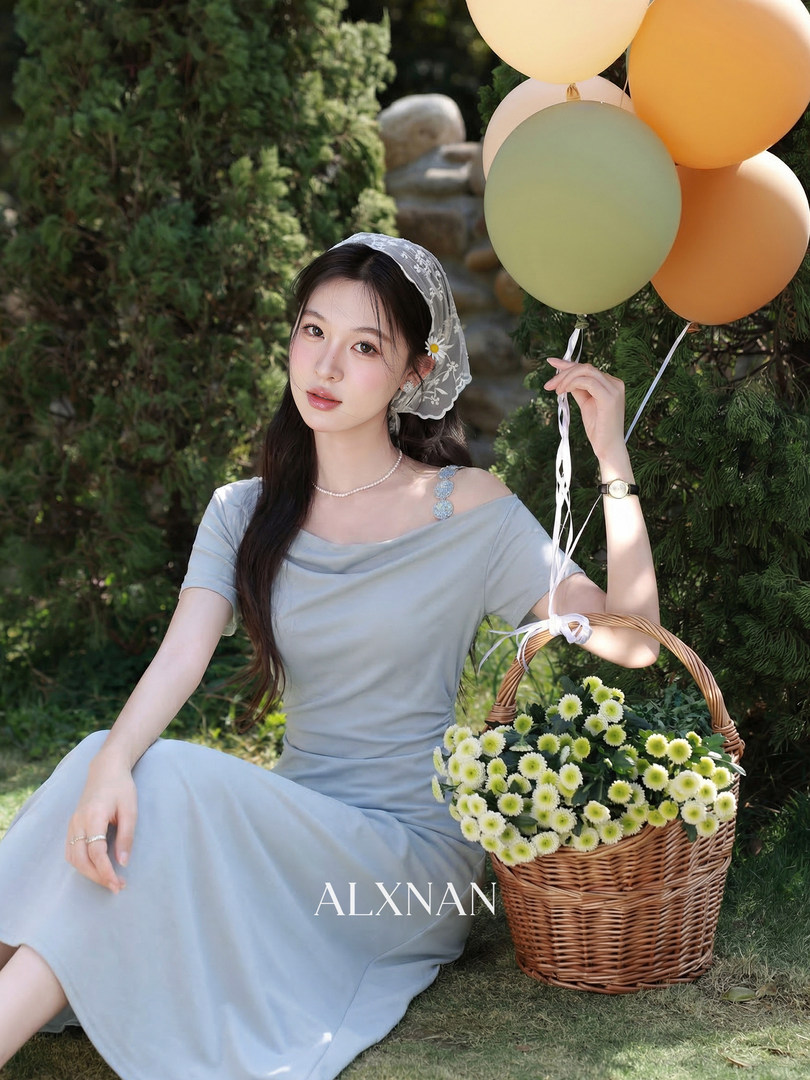 Light blue off-shoulder dress worn by a model in a garden setting