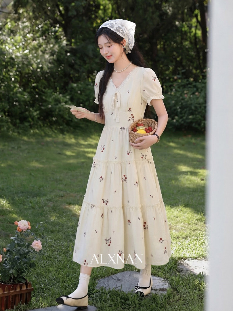 Cream floral midi dress worn by a model outdoors