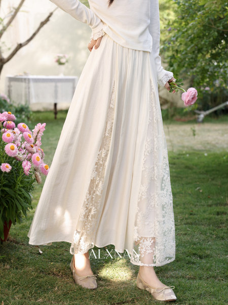 Cream flowing lace skirt worn on a model outdoors