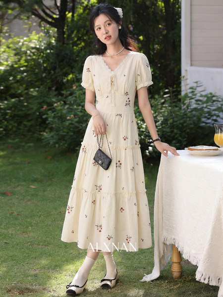 Model wearing a cream floral midi dress outdoors