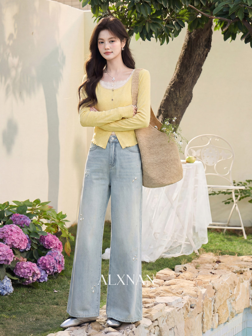 Model wearing a yellow knit top with light blue wide-leg jeans and a woven tote bag