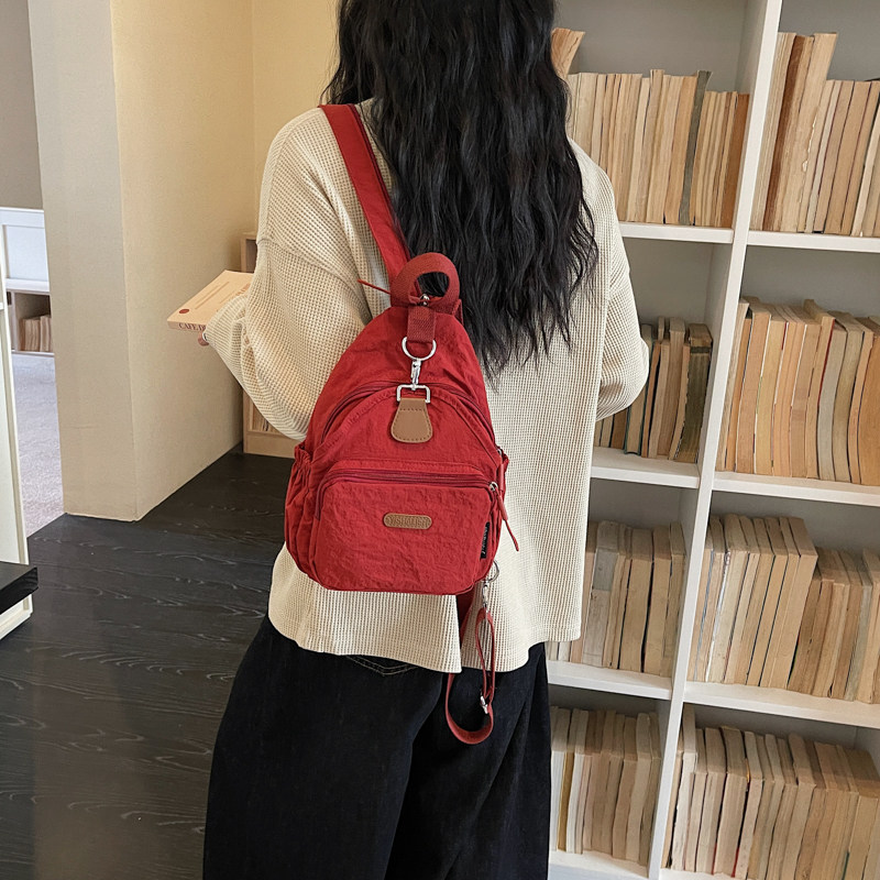 红鹮鸟多口袋女双肩包